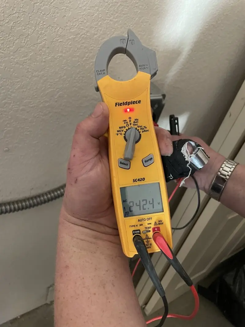Voltage testing with clamp meter during Ceiling Fan Installation in Sandwich